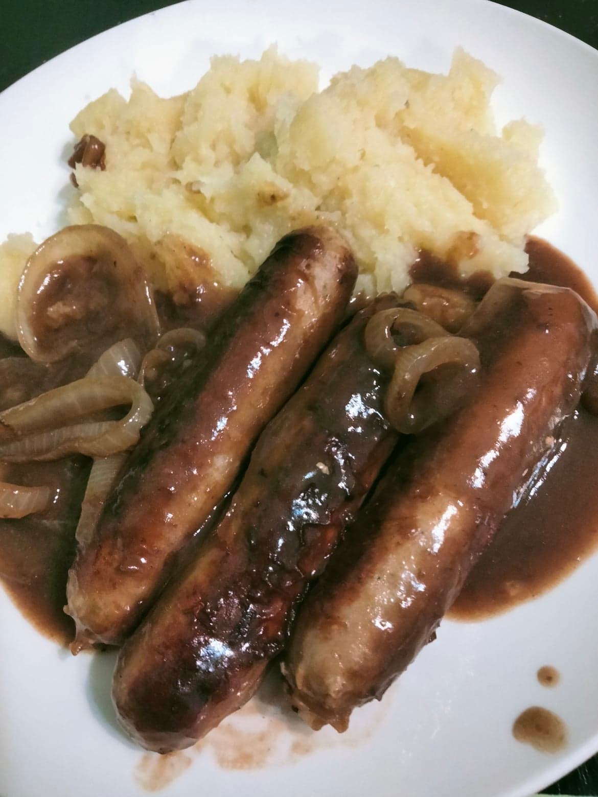 Braised sausages in onion greavy